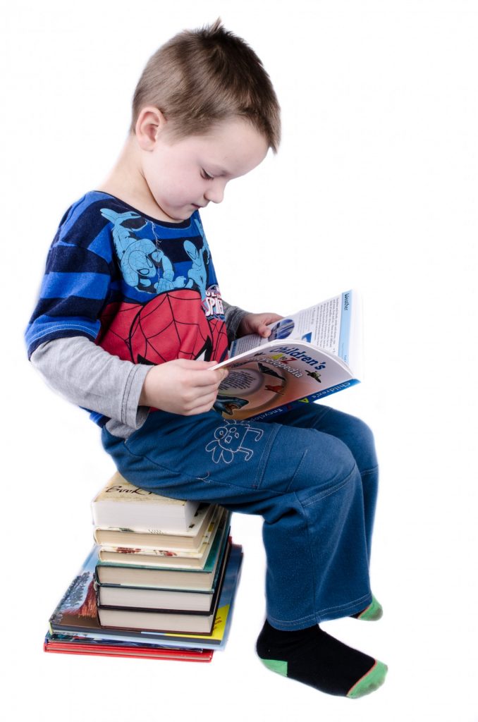 schoolboy-is-sitting-on-books